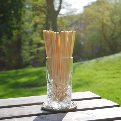 Crystal glass filled with wheat drinking straws.